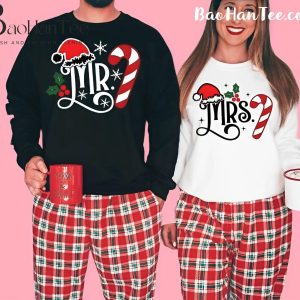 Matching Mr. and Mrs. Christmas sweaters with candy cane and Santa hat designs