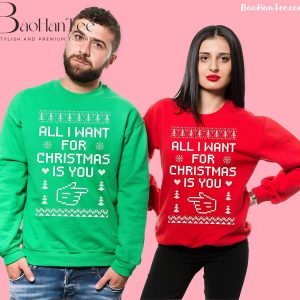 Couple wearing 'All I Want for Christmas Is You' matching Christmas sweaters