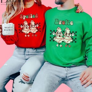 Couple wearing 'Spoiled' and 'Broke' Christmas sweaters