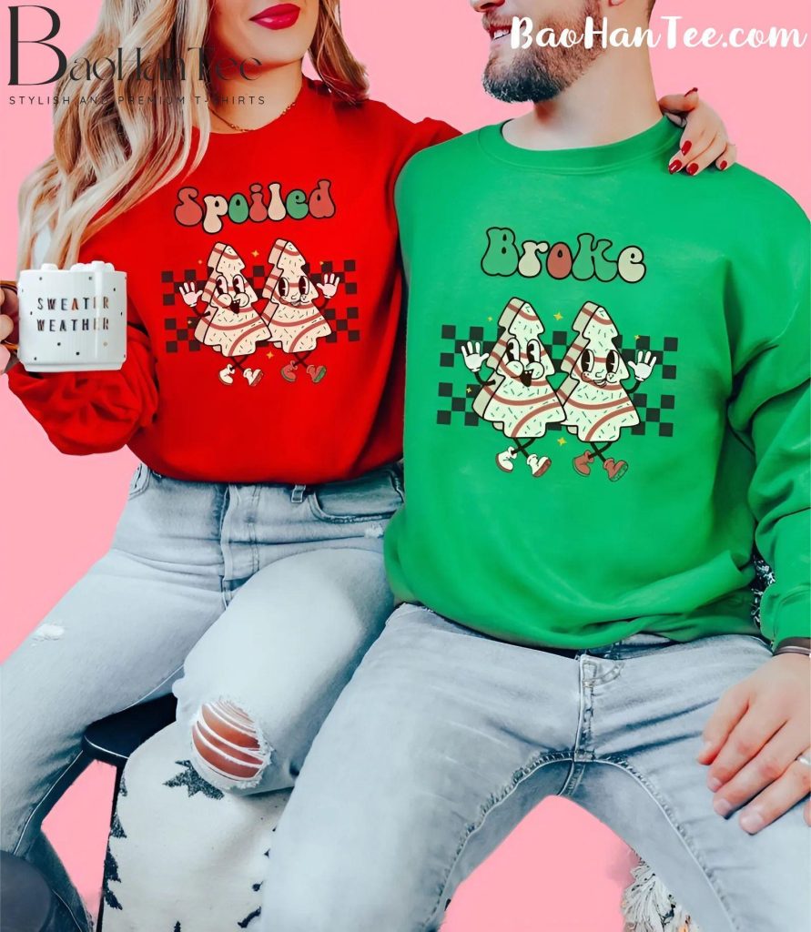 Couple wearing 'Spoiled' and 'Broke' Christmas sweaters