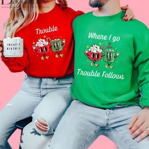 Couple wearing 'Trouble' and 'Where I Go Trouble Follows' Christmas sweaters