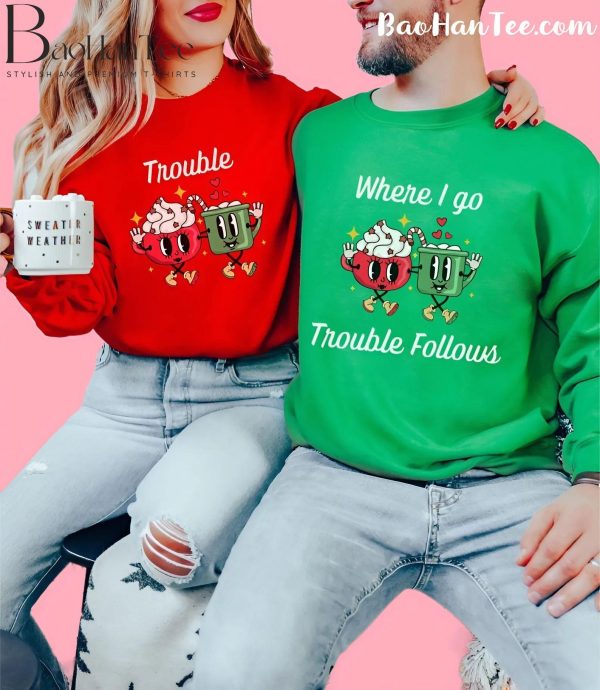 Couple wearing 'Trouble' and 'Where I Go Trouble Follows' Christmas sweaters