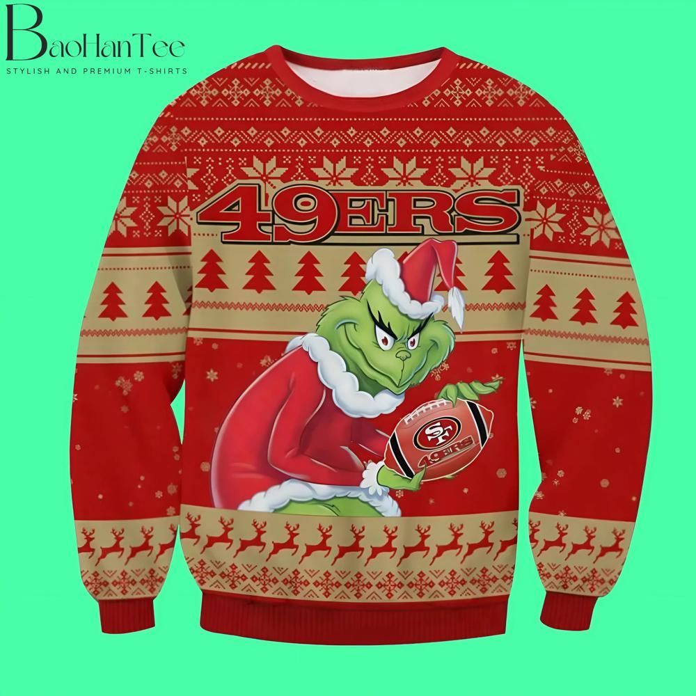 This sweater is ideal for fans of the San Francisco 49ers who want to combine their love for football with holiday cheer. The Grinch, dressed in his Santa suit, clutches a football emblazoned with the 49ers logo, looking as sly as ever.