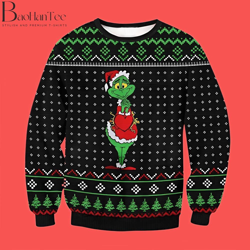 This adorable sweater captures the heartwarming moment when the Grinch’s heart grows three sizes. Dressed in his red Santa suit, the Grinch holds a large red heart, reflecting his softer side.