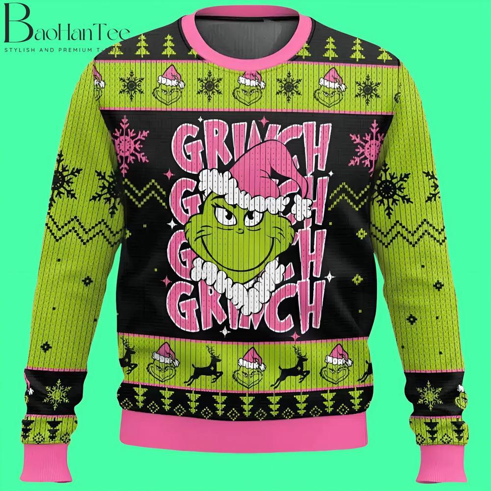 This sweater adds a unique touch with its vibrant pink accents. The Grinch wears a pink Santa hat, and the sweater features his face multiple times across the front. It’s a playful, colorful design that stands out from traditional holiday colors.