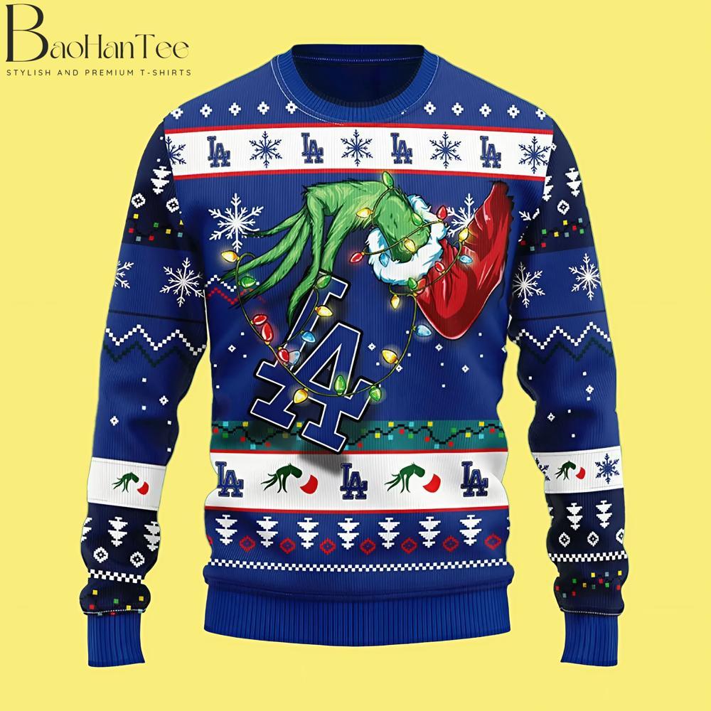 Combining the Grinch with the LA Dodgers, this sweater is perfect for Dodgers fans looking to add a bit of mischief to their holiday wardrobe. The Grinch is tangled up in colorful Christmas lights, holding a Dodgers logo with a playful smirk.