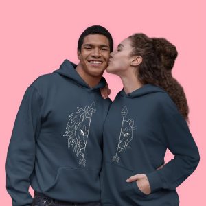 Couple wearing navy blue matching lion hoodies, smiling and embracing.